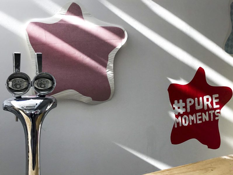 A tap-inspired office branding wall featuring a prominent star emblem.