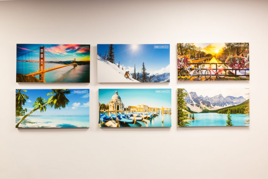 A collection of office branding pictures adorning a wall.
