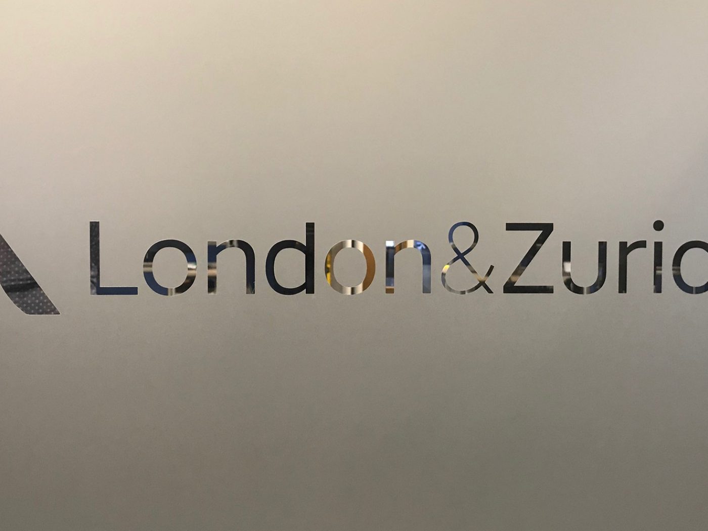 A London & Zurich office branding sign.