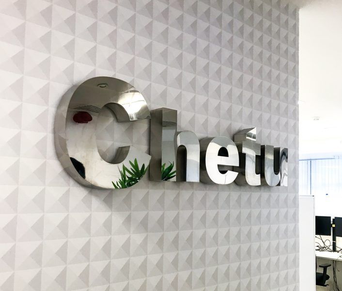 An office with a sign that says chetu.