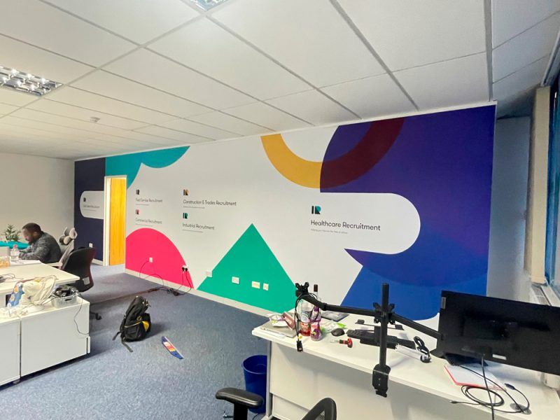 An office with a colorful wall mural.